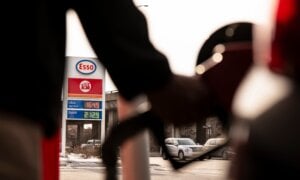 Fuel prices are displayed as a person fills up their car with gas at a station in Montreal on Thursday, March 5, 2026.