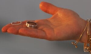 A marriage official offers a couple their rings during their wedding in New York, Wednesday, Feb. 14, 2007
