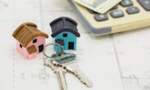 House keys sitting on papers with a calculator