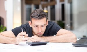 Young man leaning on table and working.