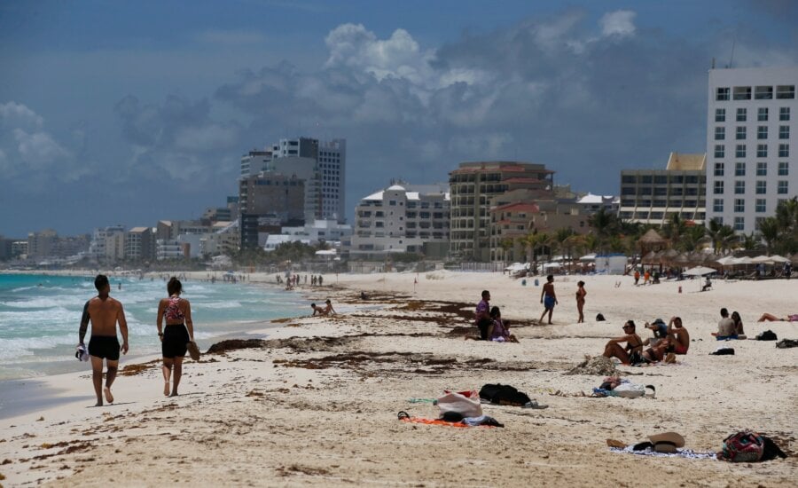Tourists enjoy the beach before the arrival of Hurricane Grace, in Cancun, Quintana Roo State, Mexico, Wednesday, Aug. 18, 2021. Residents and tourists along the Caribbean coast began making preparations for Grace, a storm that drenched Haiti and Jamaica and is now forecast to hit Mexico´s Yucatan peninsula like a hurricane early Thursday morning.
