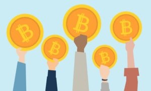 People holding up cryptocurrency coins