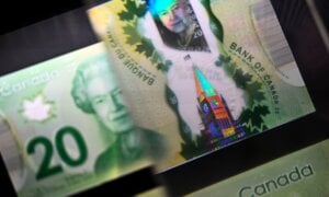 A magnifying glass enlarges the holographic image of Parliament Hill's Peace Tower on a $20 bill issued by the Bank of Canada, shown in a display case at the Bank of Canada Museum in Ottawa, on Wednesday, Sept. 4, 2024.