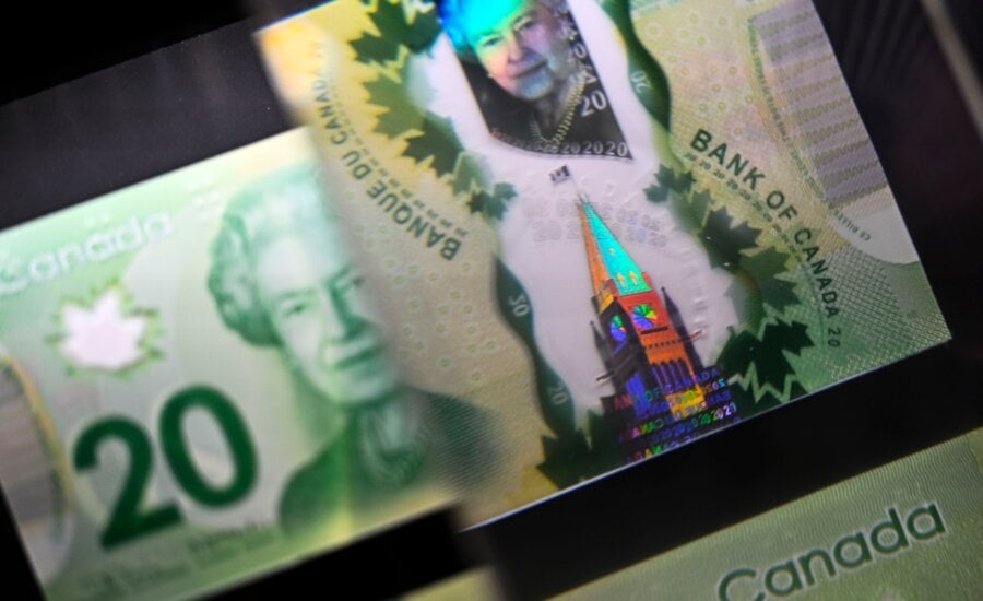 A magnifying glass enlarges the holographic image of Parliament Hill's Peace Tower on a $20 bill issued by the Bank of Canada, shown in a display case at the Bank of Canada Museum in Ottawa, on Wednesday, Sept. 4, 2024.