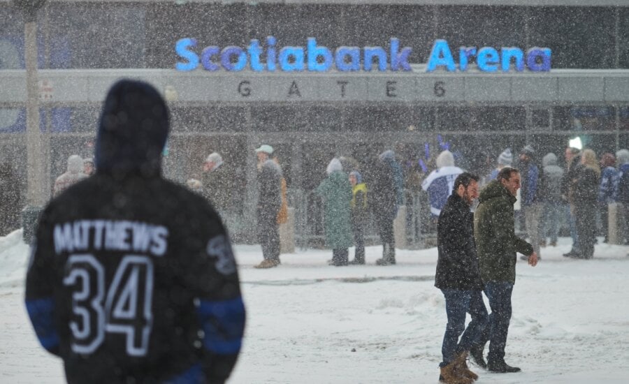 Toronto Maple Leafs fans line up in a snowstorm as they wait to enter Scotiabank arena ahead of NHL hockey action against the Colorado Avalanche in Toronto, on Sunday, Jan. 25, 2026.