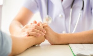 female psychologist consulting patient at the desk in hospital. Medicine and health care concept