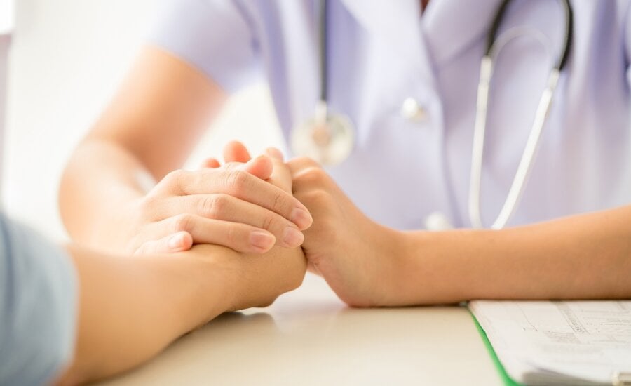 female psychologist consulting patient at the desk in hospital. Medicine and health care concept