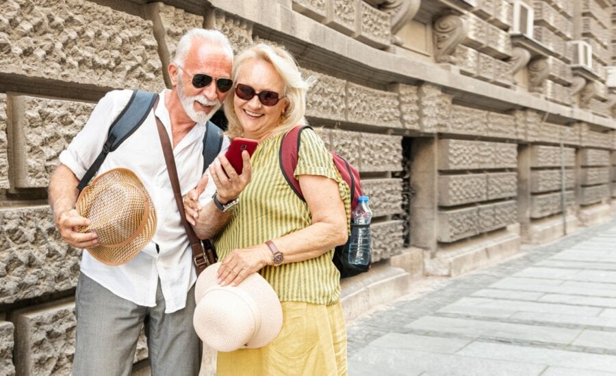 Older couple taking a selfie while traveling