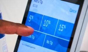 Customers are presented with a tip option screen at a restaurant in Toronto, on Wednesday, Aug. 20, 2025.