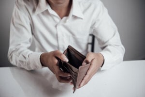 Man showing an empty wallet