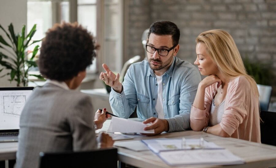 Young couple speaking to a financial advisor