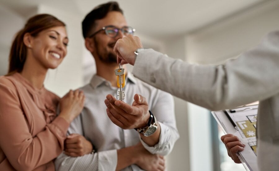 Happy couple getting keys to their new house