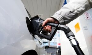 A woman pumps gas at a gas station in Mississauga, Ont., on Feb. 13, 2024.