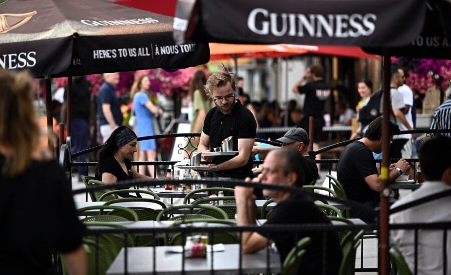 A server works on the patio of a pub in the ByWard Market in Ottawa, on Friday, June 23, 2023.
