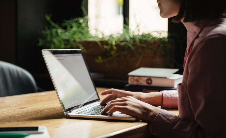 Woman working on a laptop at a table