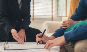 Couple signing a document