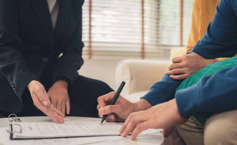 Couple signing a document