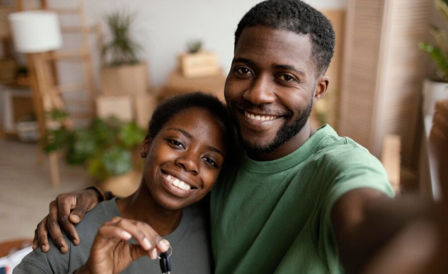 Couple smiling holding new house keys