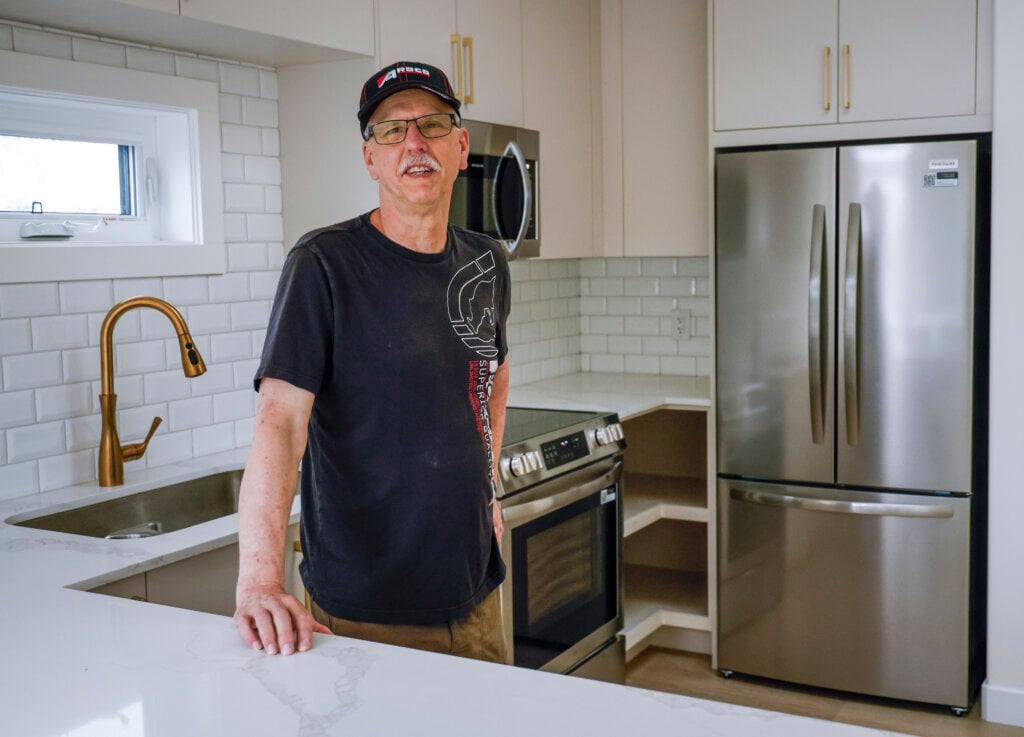 Calgary resident Eugene Blanchard, who built a laneway home for his daughter and son-in-law, shows off the home in Calgary, Tuesday, July 14, 2026.