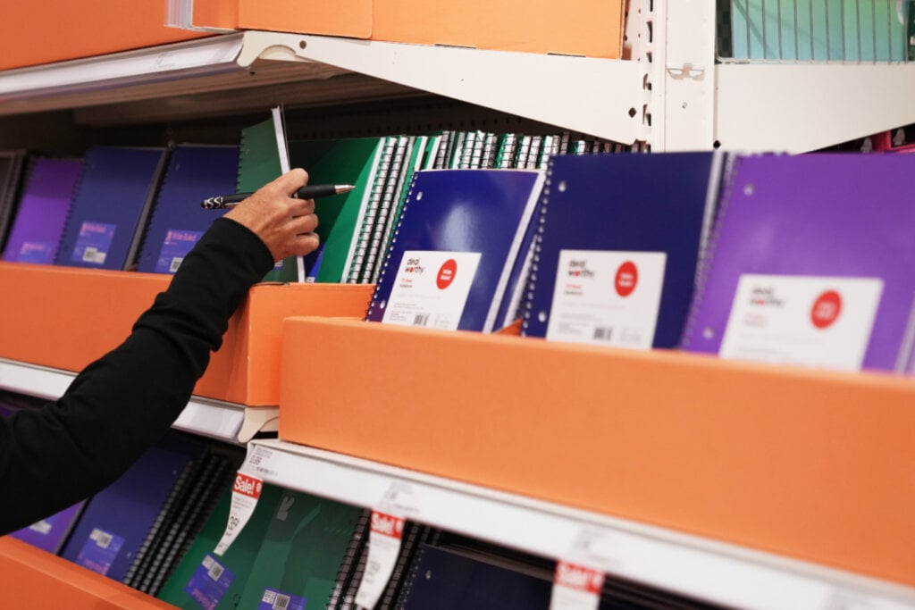 A shopper selects a notebook in the back-to-school section at a Target store, Thursday, Aug. 13, 2026, in Woodbury, Minn.