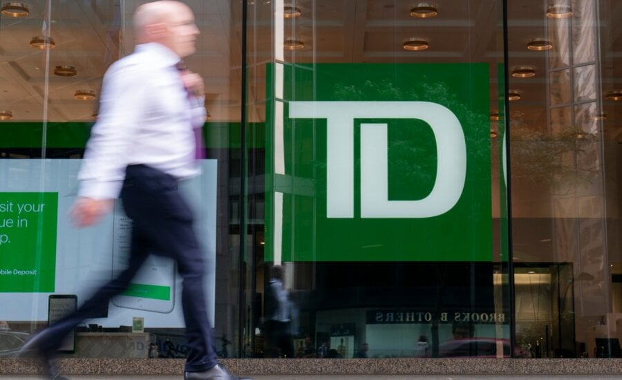 A person makes their way past a Toronto-Dominion Bank in the Financial District of Toronto, Monday, Aug. 14, 2023.