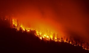 The Quilpituk Creek wildfire burns on the west side of Okanagan Lake near Fintry, B.C., late Monday, Aug. 3, 2026.