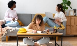 Three female roommates sitting in a living room