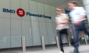 People make their way past the Bank of Montreal (BMO) building in Toronto's financial district, Monday, Aug. 14, 2023.