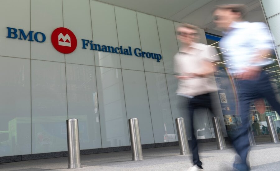 People make their way past the Bank of Montreal (BMO) building in Toronto's financial district, Monday, Aug. 14, 2023.