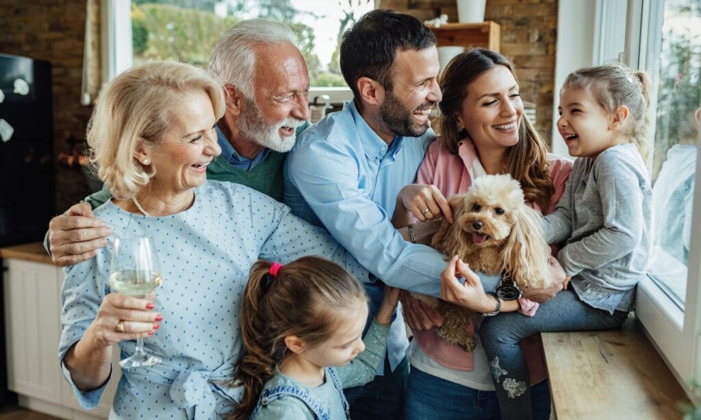 Cheerful multi-generation family with a dog having fun while spending time together at home.