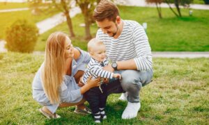 Young couple with baby in the park