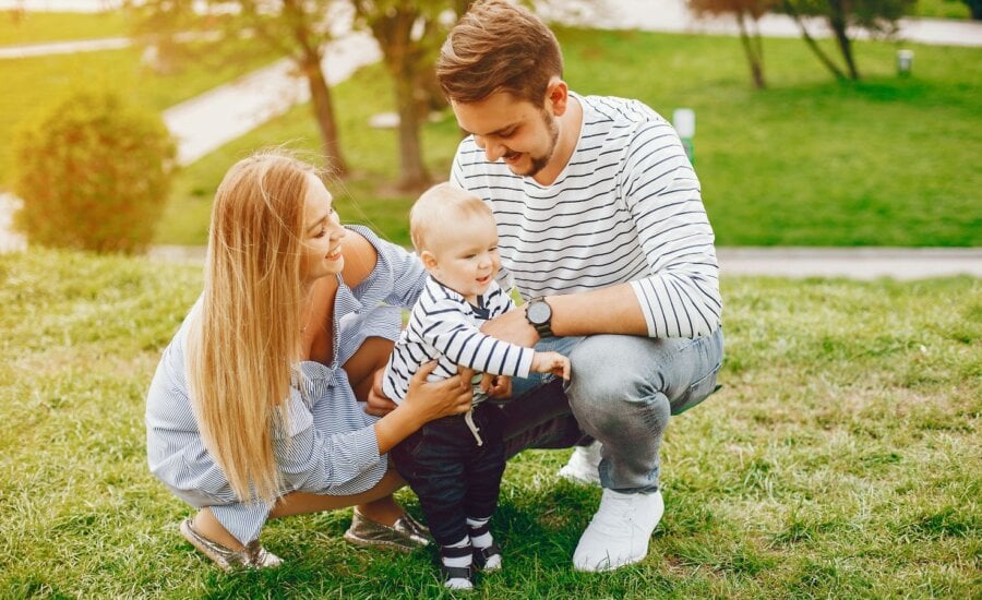 Young couple with baby in the park