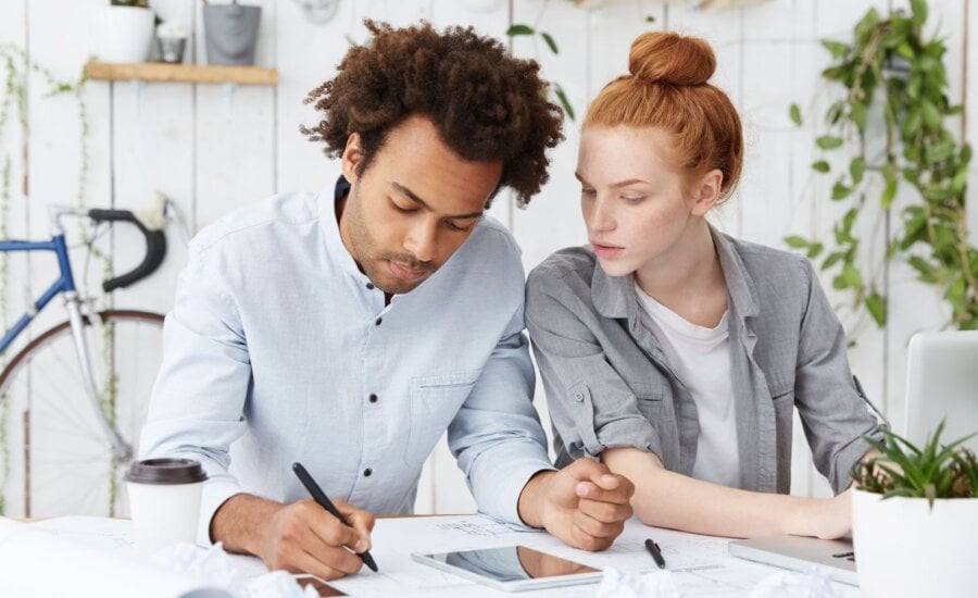 Two young people working at a table